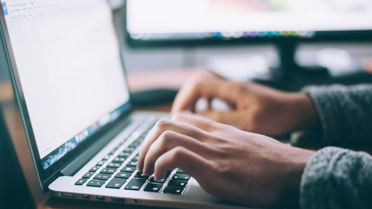 Content strategist drafting structured editorial answers and direct insights on laptop